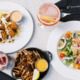 A delicious spread of crab claws, salad, and drinks