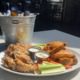 An ice cold bucket of beers with wings two-ways for Labor Day Weekend in Atlanta